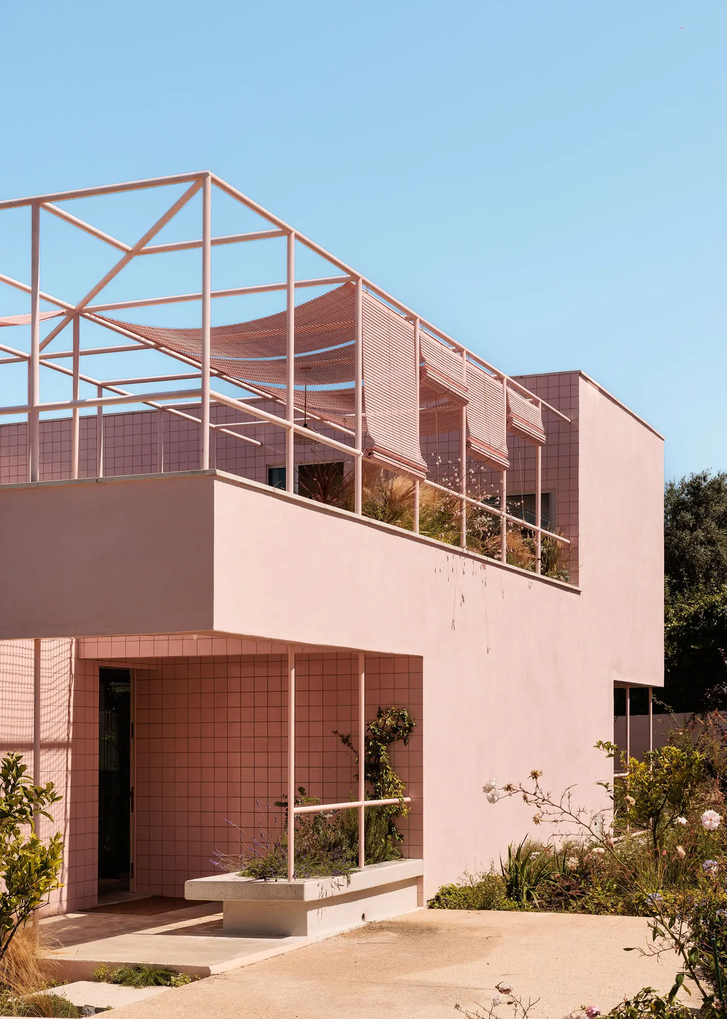 Casa Galamares atelier RUA Sintra two-storey pink ceramic tile facade tubular steel pergola ground floor entrance garden vegetation