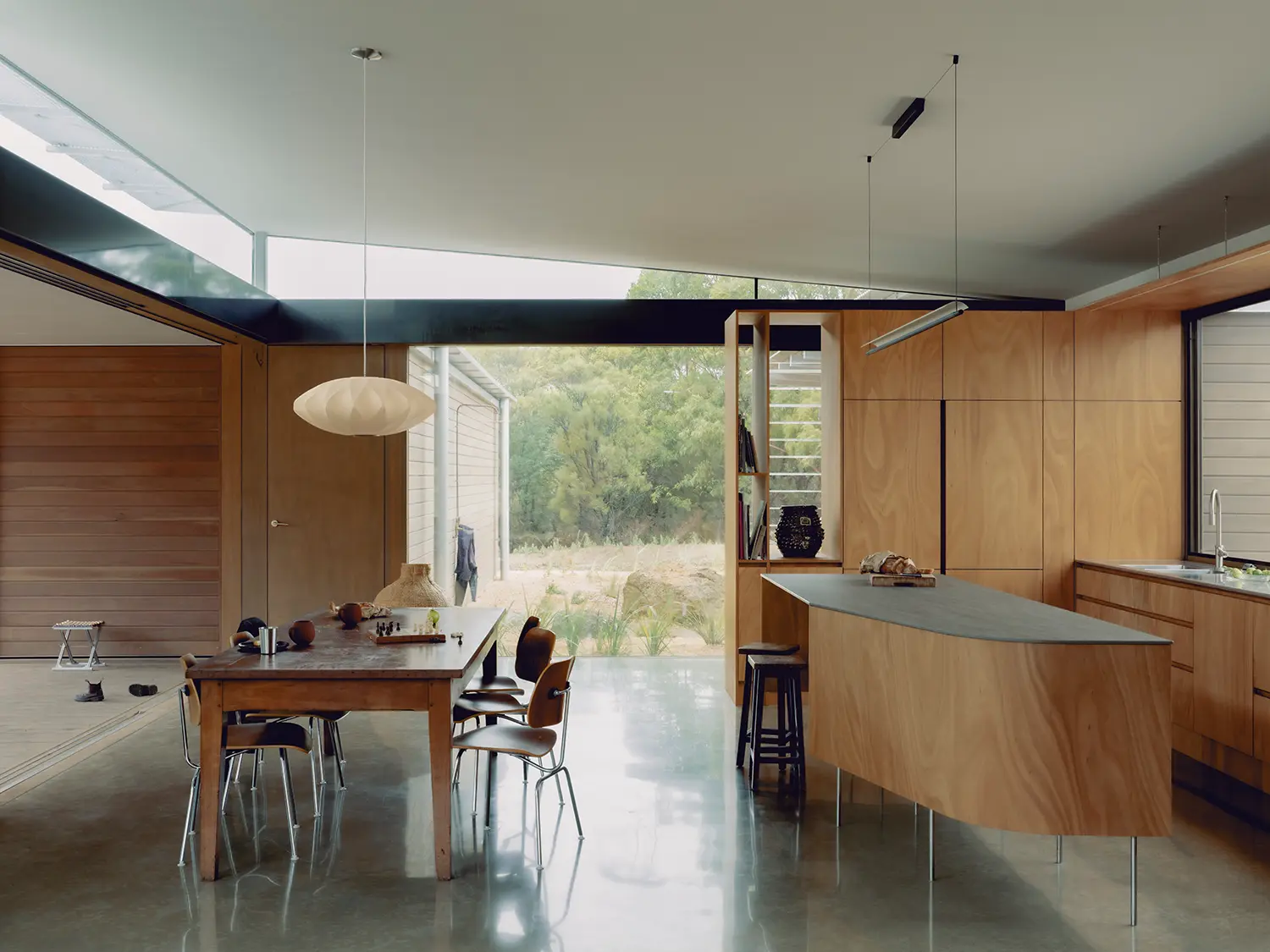 Ironbark House Not All Architecture open plan kitchen dining polished concrete floor plywood cabinetry clerestory glazing stack ventilation gap