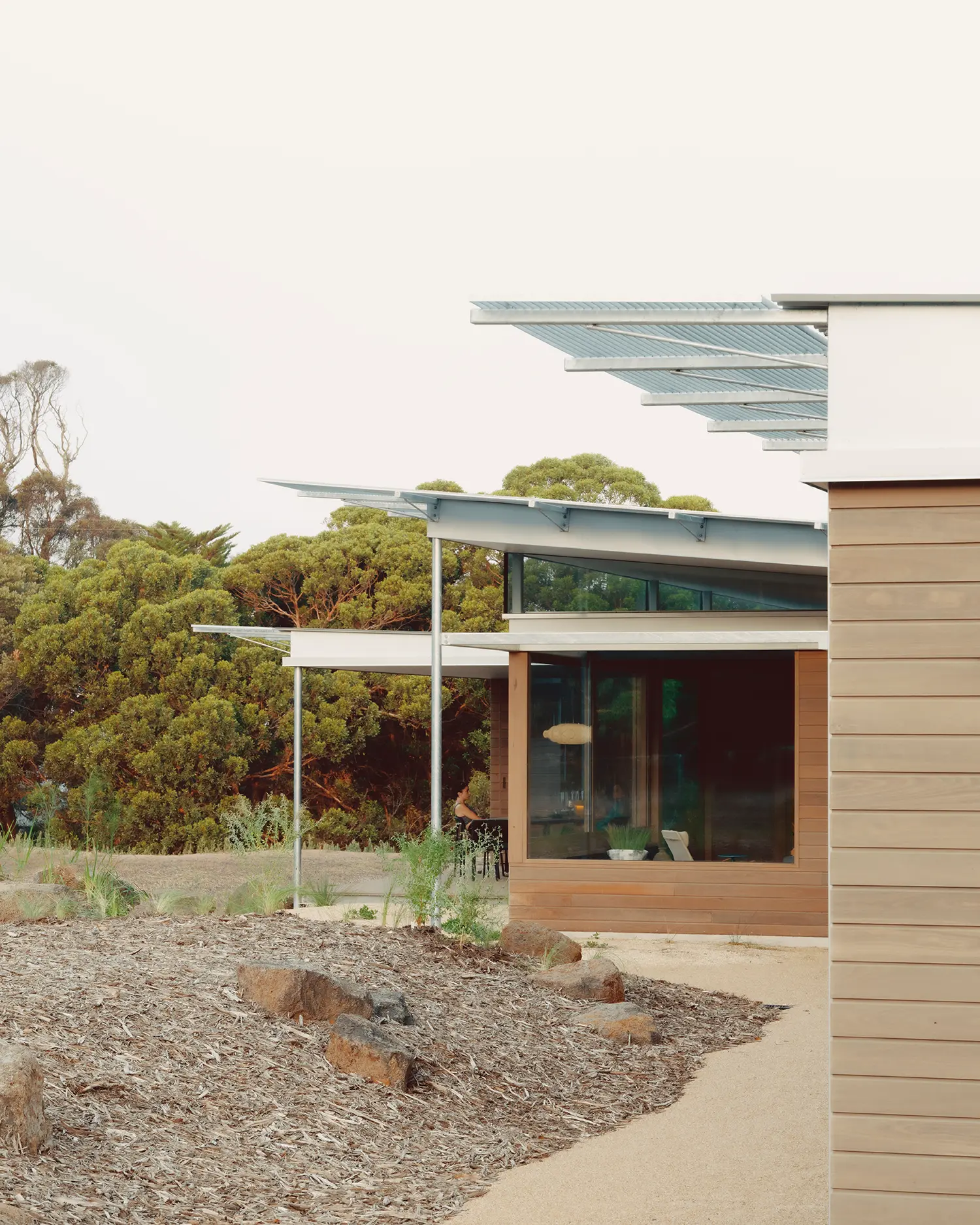 Ironbark House Not All Architecture exterior evening galvanized steel roof canopy ironbark cladding clerestory glazing coastal scrub dusk
