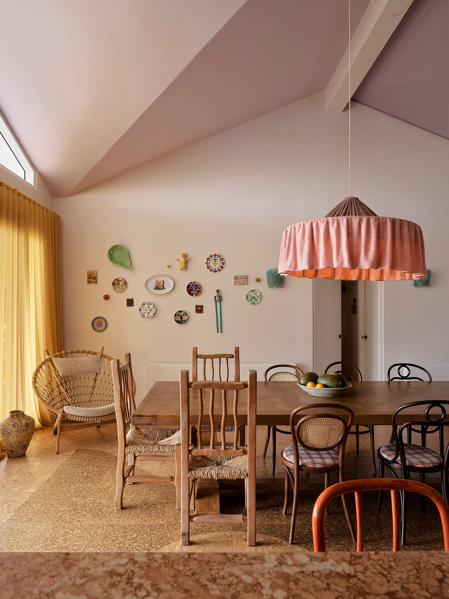 Plantasia YSG Studio New South Wales dining room mismatched timber chairs farmhouse table salon wall hang pink pendant cork floor
