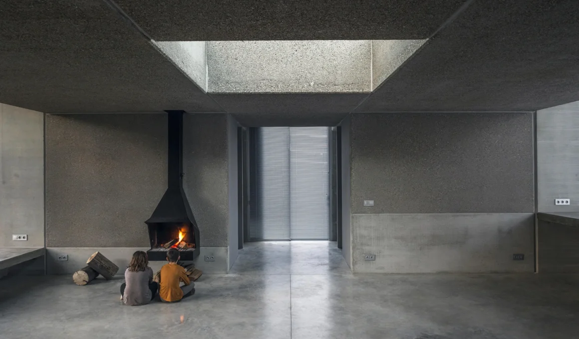 Prefab Pavilion Jordi Hidalgo Tané Olot concrete interior skylight fireplace polished floor two figures