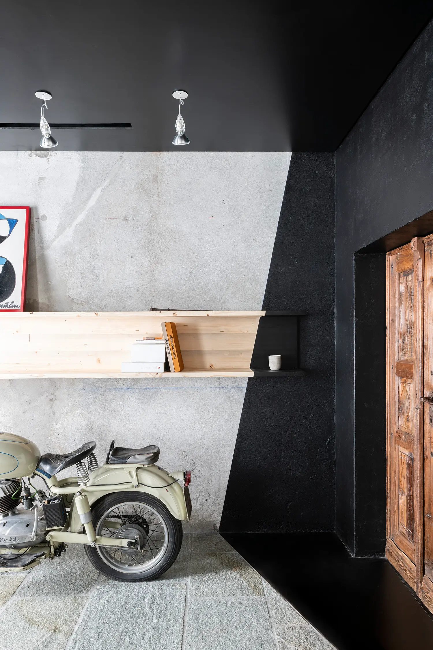RAW Studio Moroni Architettura Sondrio black diagonal raw plaster wall vintage motorcycle pine shelving art print