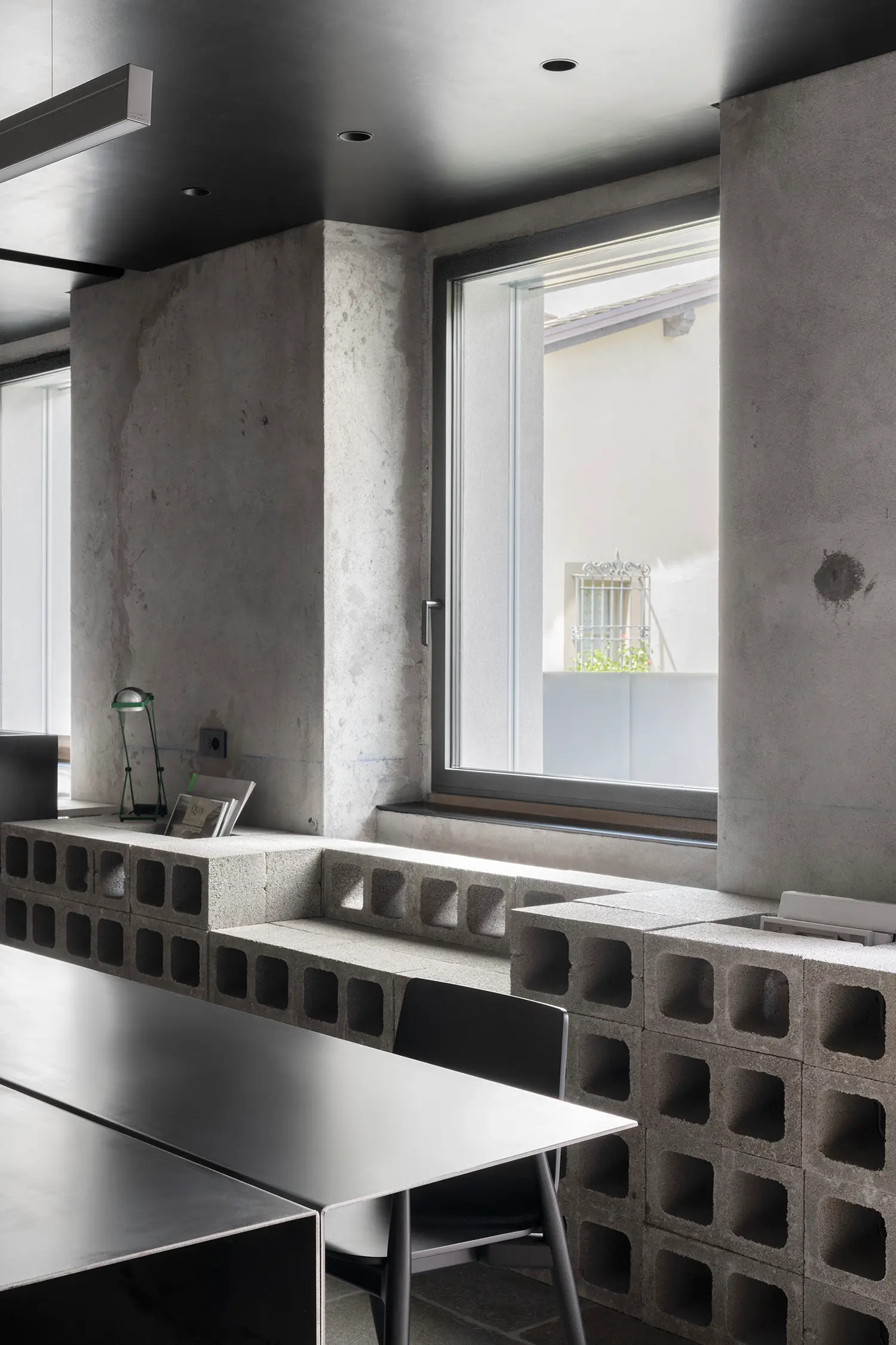 RAW Studio Moroni Architettura Sondrio perforated concrete blocks dry assembled shelving iron table window raw plaster
