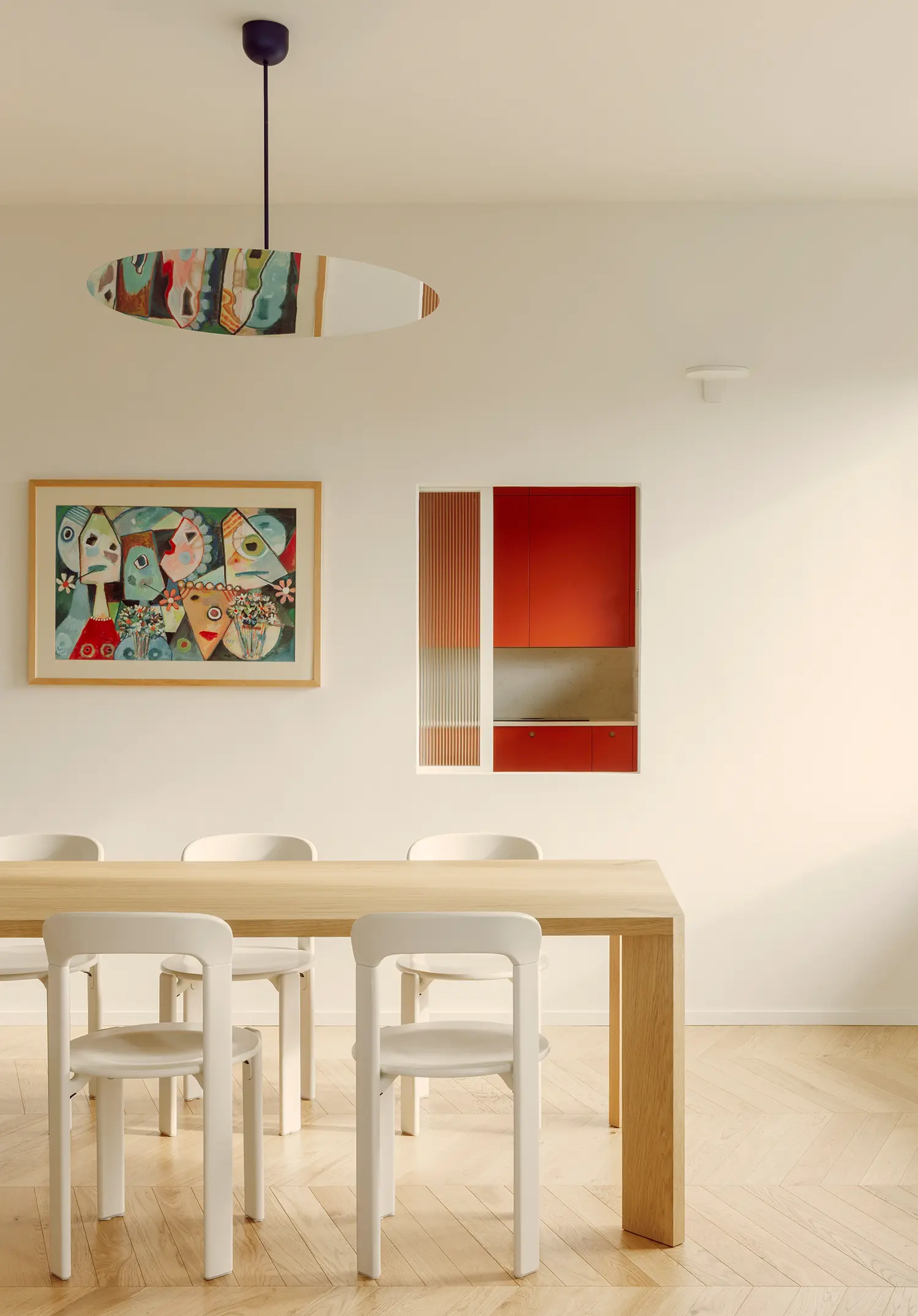 The Lobster bucci quentin, dining room with lobster red kitchen joinery visible through opening, herringbone parquet, Prato 2026