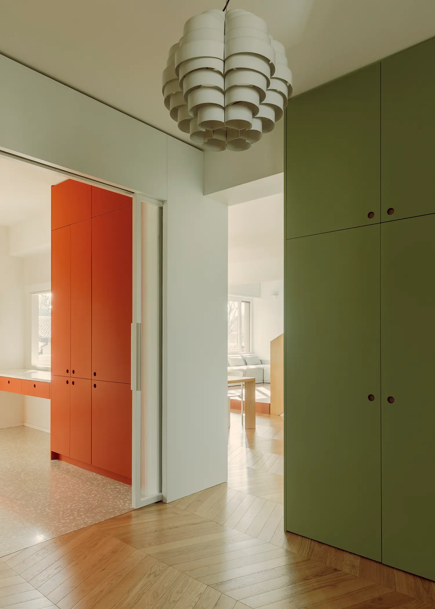 The Lobster bucci quentin, entrance hall with olive green floor-to-ceiling millwork and lobster red kitchen beyond, Prato 2026