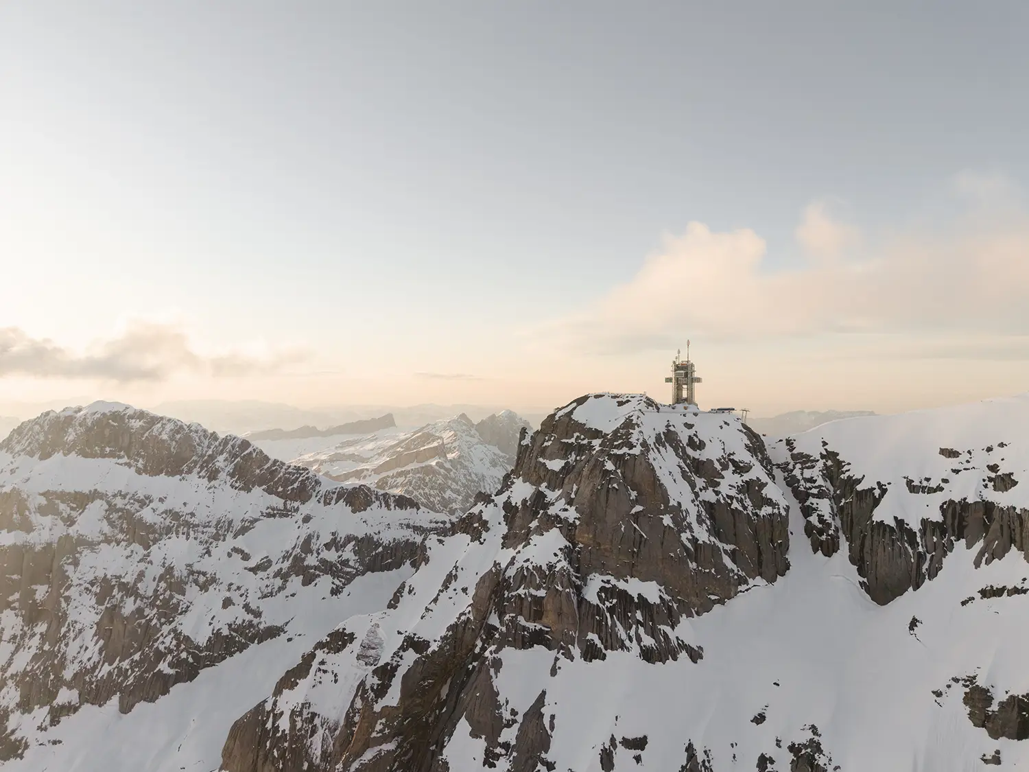 TITLIS Tower Herzog de Meuron distant aerial alpine landscape Engelberg Switzerland summit dusk golden hour