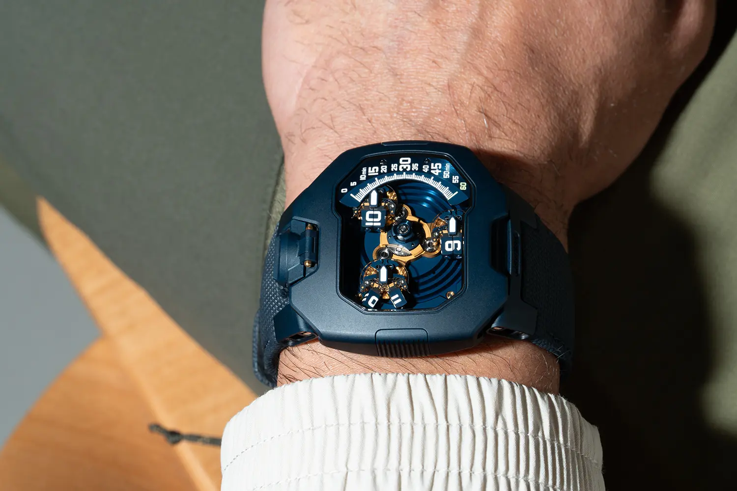 URWERK UR-120 Blue Planet dial view from above on wrist, three satellite hour indicators, gold PVD Calibre UR-20.01, blue ALD display, minute track