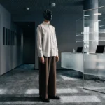 Faceless businessman in helmet standing in modern office, symbolizing AI readiness and business integration challenges