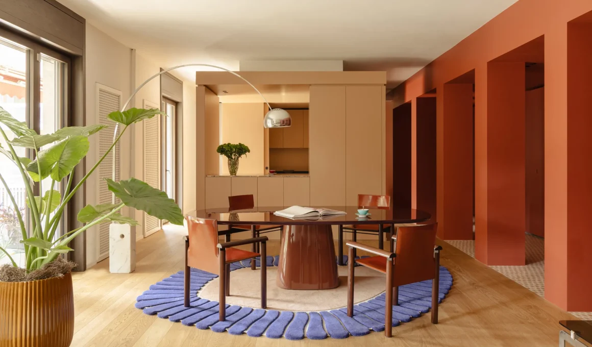 THAT Z SHOW apartment by Atelierzero, Milan, dining area with round dark red table and blue scalloped rug
