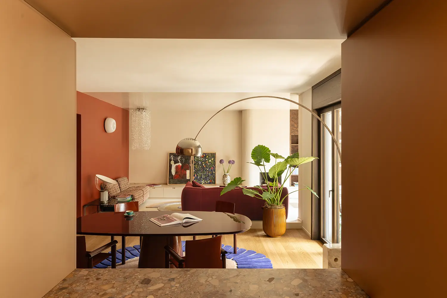 THAT Z SHOW apartment Milan, Atelierzero, living area with burgundy sofa and terracotta accent wall