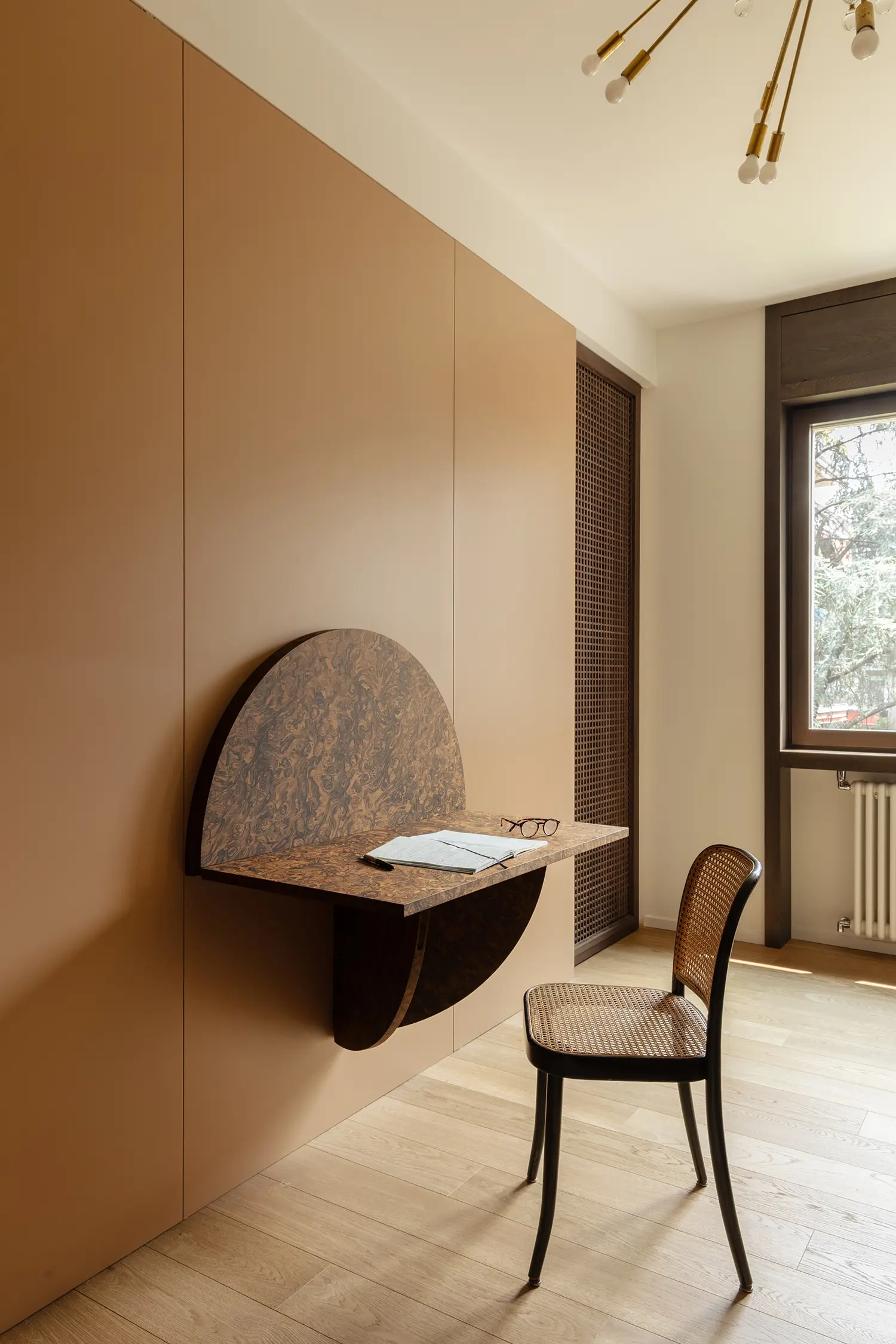 THAT Z SHOW apartment by Atelierzero, custom wall-mounted desk in burl wood with cane chair