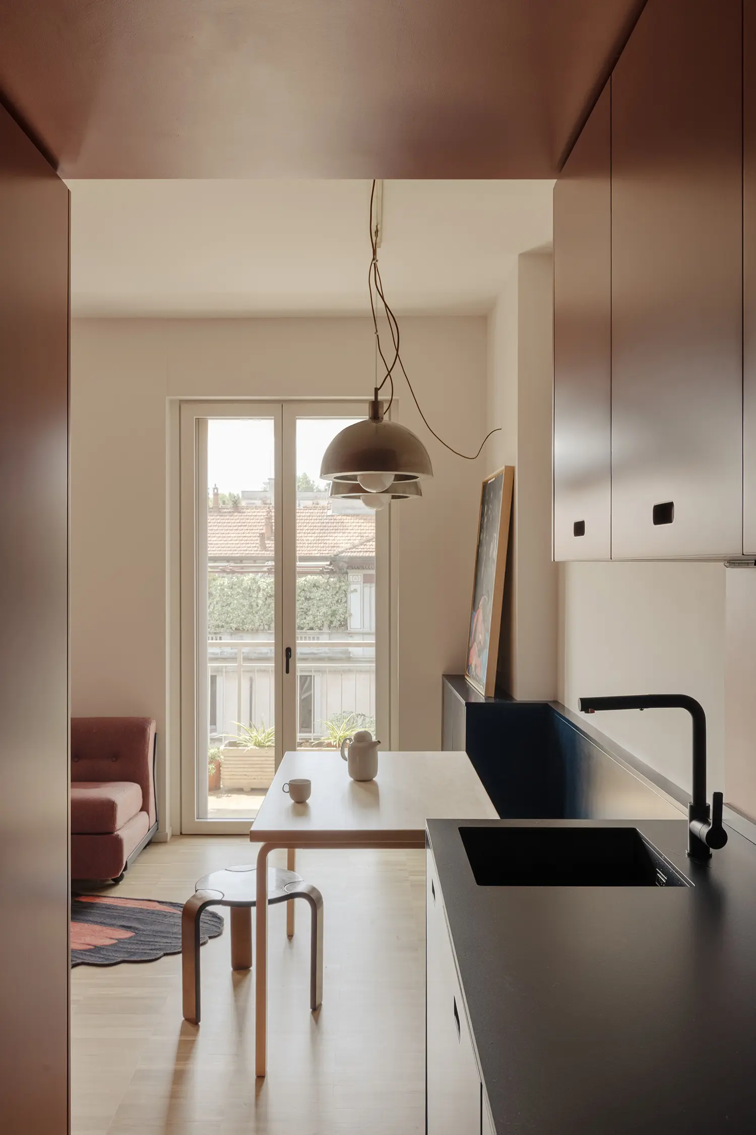 THAT Z SHOW apartment by Atelierzero, kitchen and dining nook with brass pendant lamp overlooking terrace