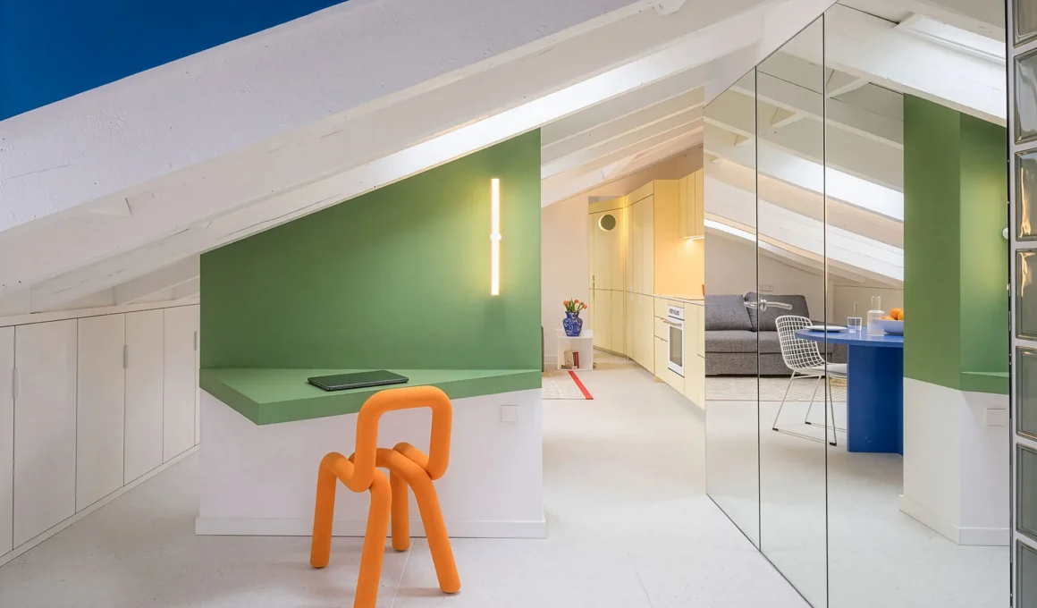 Attic apartment at night by gon architects, orange sculptural chair, mirrored wall reflecting living room beyond