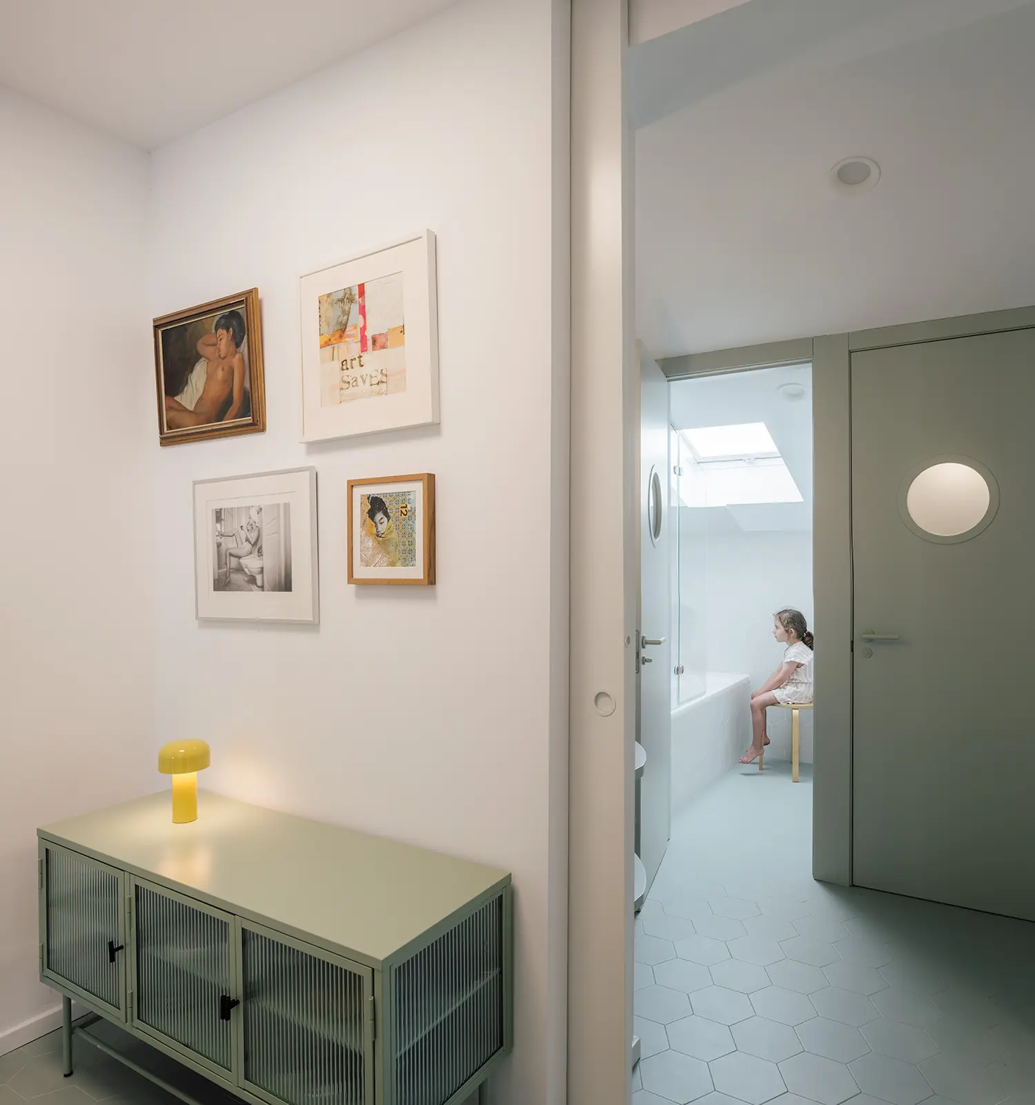 Attic bedroom with sage green walls, pitched skylight window, gon architects Madrid renovation