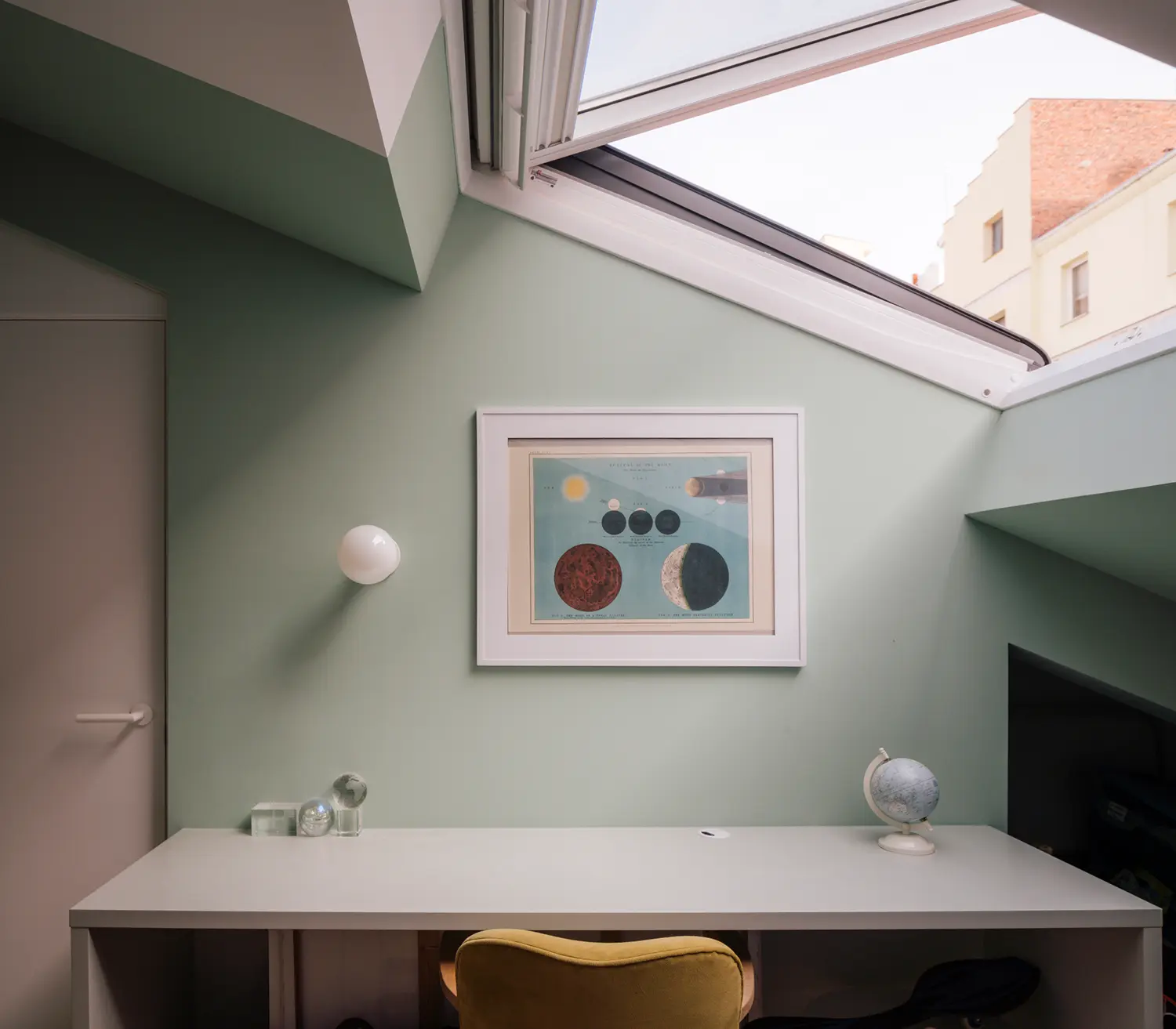 Attic bathroom with skylight and hexagonal tile, adjoining nursery with circular ceiling light fixture