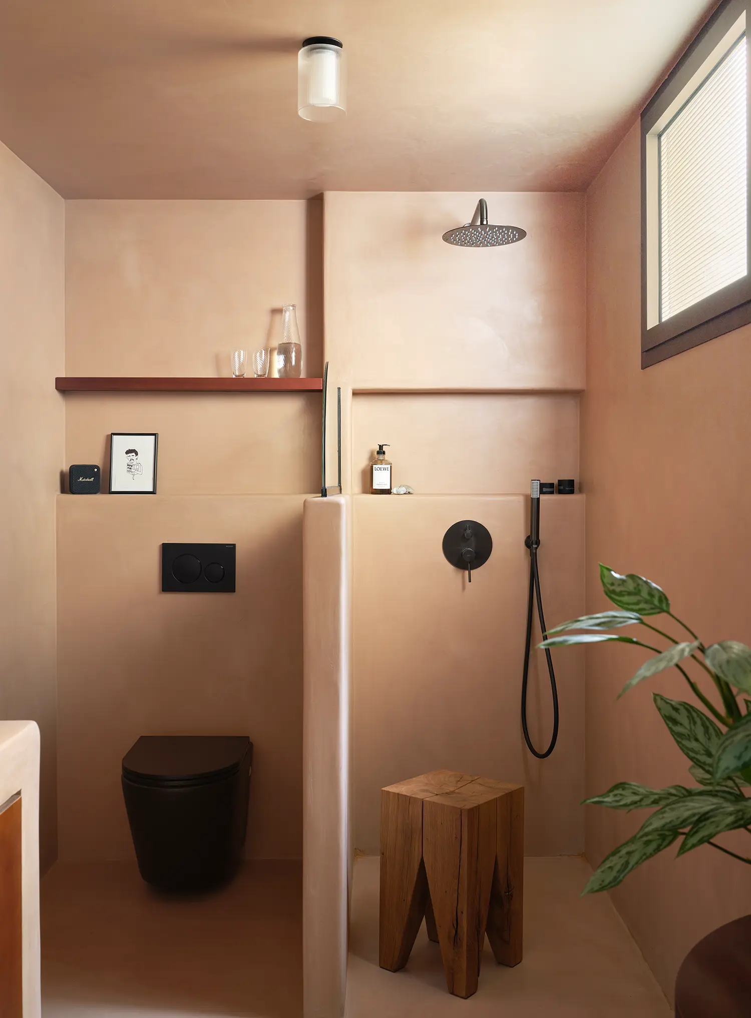 Macedonia by Bardo, terracotta-toned bathroom with matte black fixtures and rainfall shower