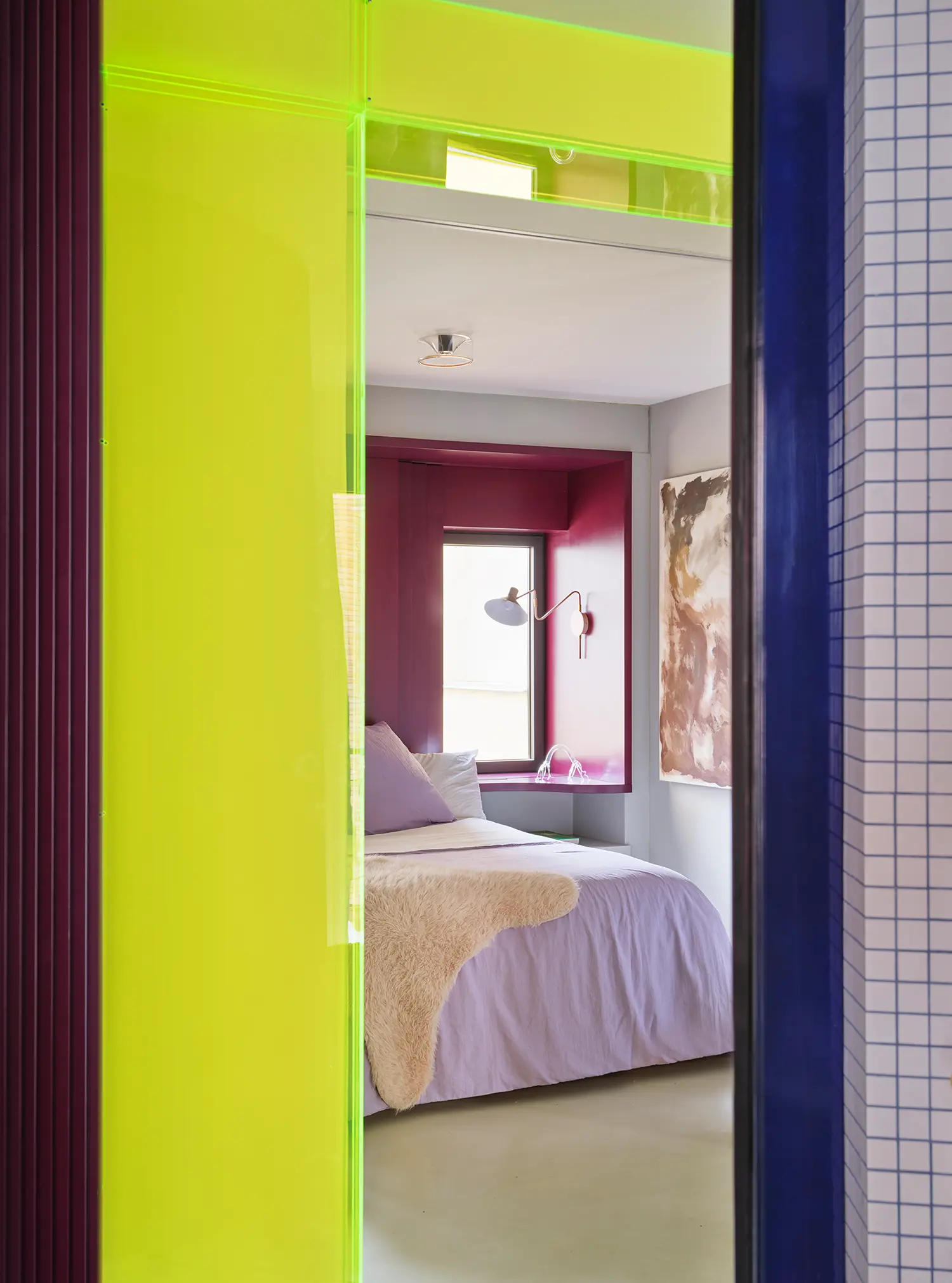 Macedonia by Bardo, view through neon acrylic doorway into bedroom with magenta window nook