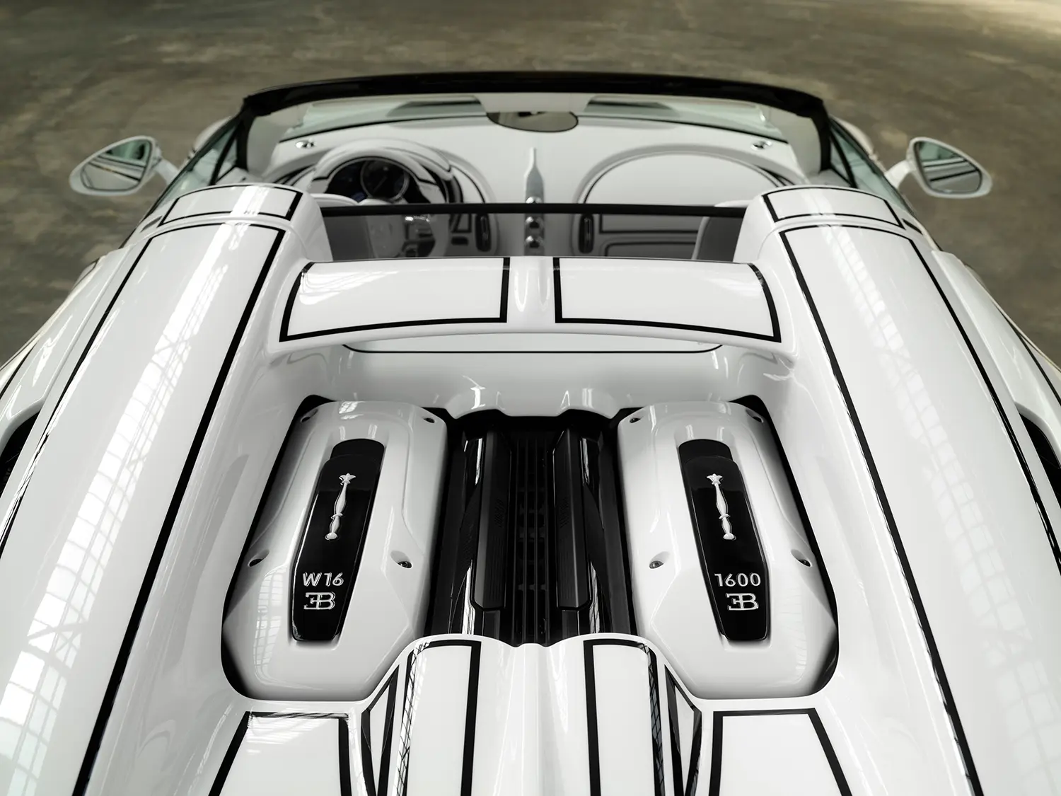 Bugatti W16 Mistral 'Blanc Éternel', overhead view of engine cover louvres with W16 and 1600 porcelain badge plaques, cockpit visible beyond