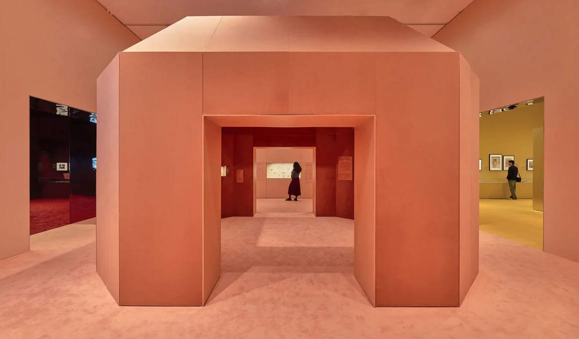 CARTIER exhibition at NGV Melbourne, designed by Studio Sabine Marcelis and CLOUD: salmon-pink volumetric passage with chamfered corners connecting gallery zones