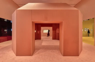 CARTIER exhibition at NGV Melbourne, designed by Studio Sabine Marcelis and CLOUD: salmon-pink volumetric passage with chamfered corners connecting gallery zones