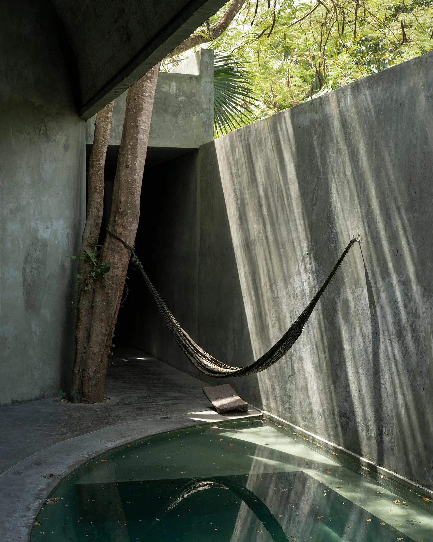 Casa Gruta hammock corridor in pigmented concrete beside a plunge pool, Salvador Román & Adela Mortera, Valladolid