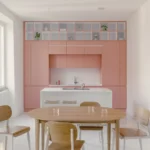 Casa Tahiti by Margine, pink kitchen and dining area, white Krion island, oak table, Arabescato terrazzo flooring