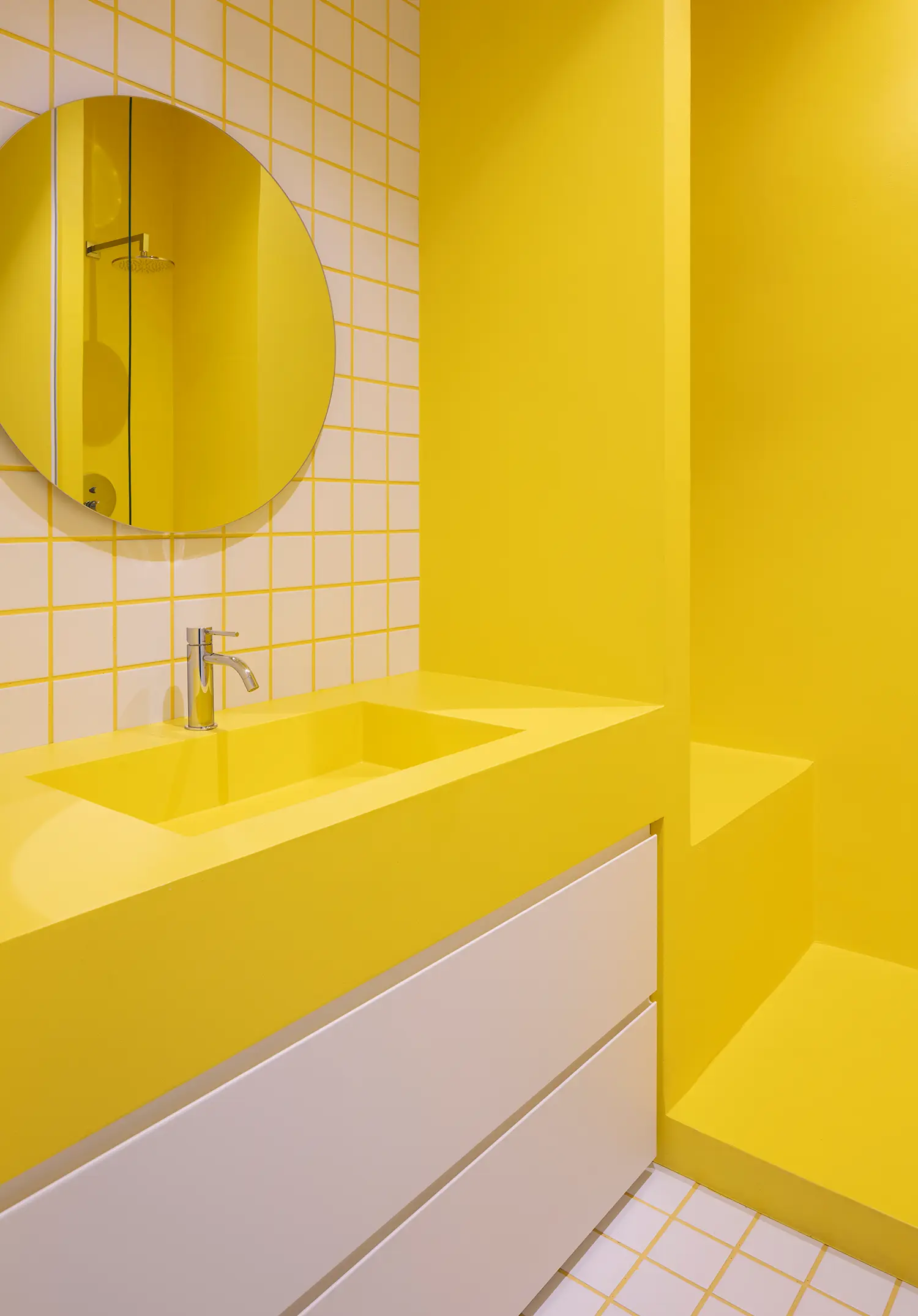 Casa Tahiti by Margine, yellow master bathroom, circular mirror, integrated washbasin, ceramic grid tiles