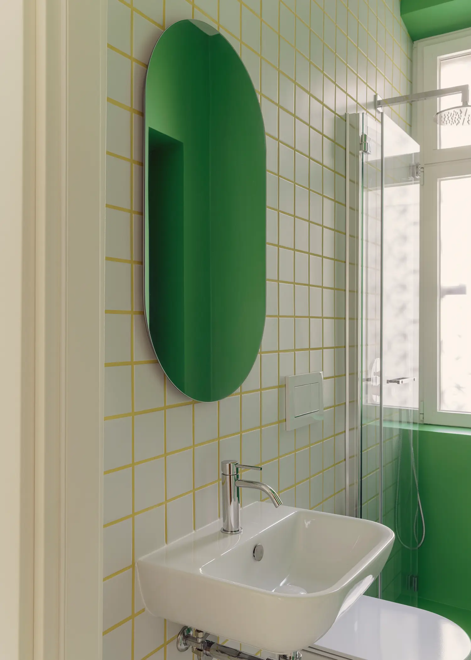 Casa Tahiti by Margine, green annex bathroom, oval green mirror, ceramic tiles with colored grout, glass shower