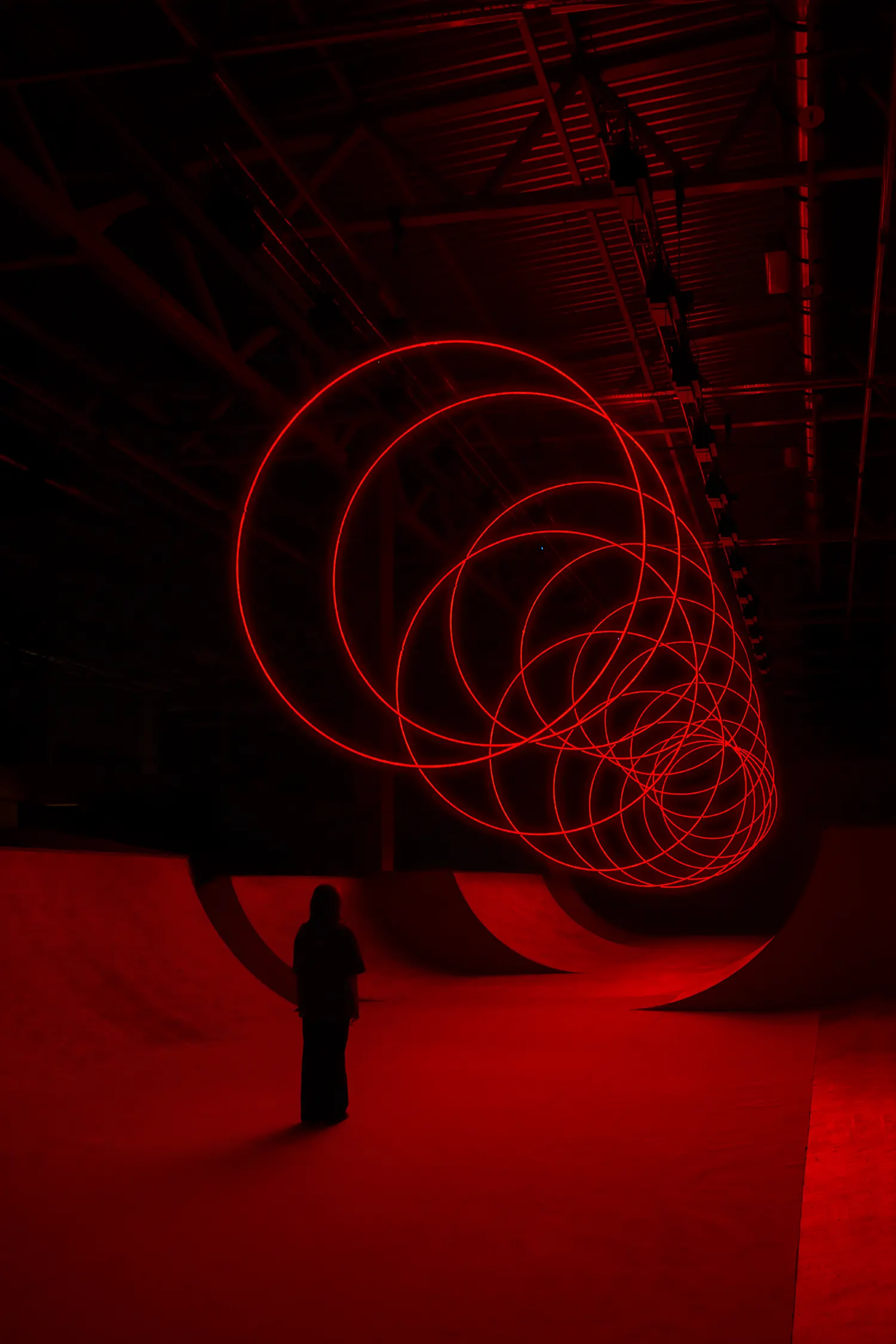 Wide diagonal shot of SpY's CYCLES N2 kinetic rings expanding across the ceiling of the Kazan venue