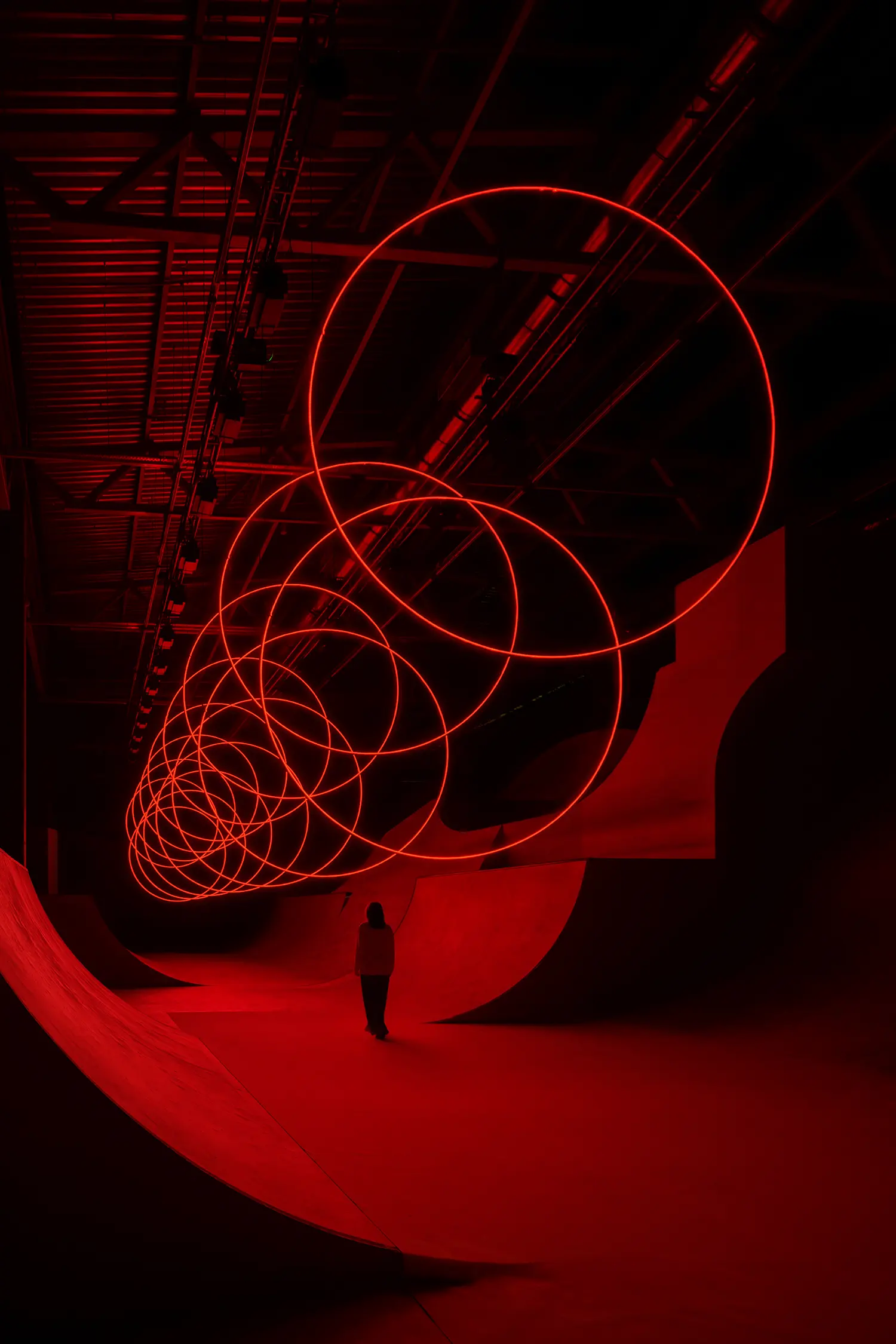 SpY's CYCLES N2 rings coiling diagonally above a viewer standing near the base of a curved ramp in Kazan