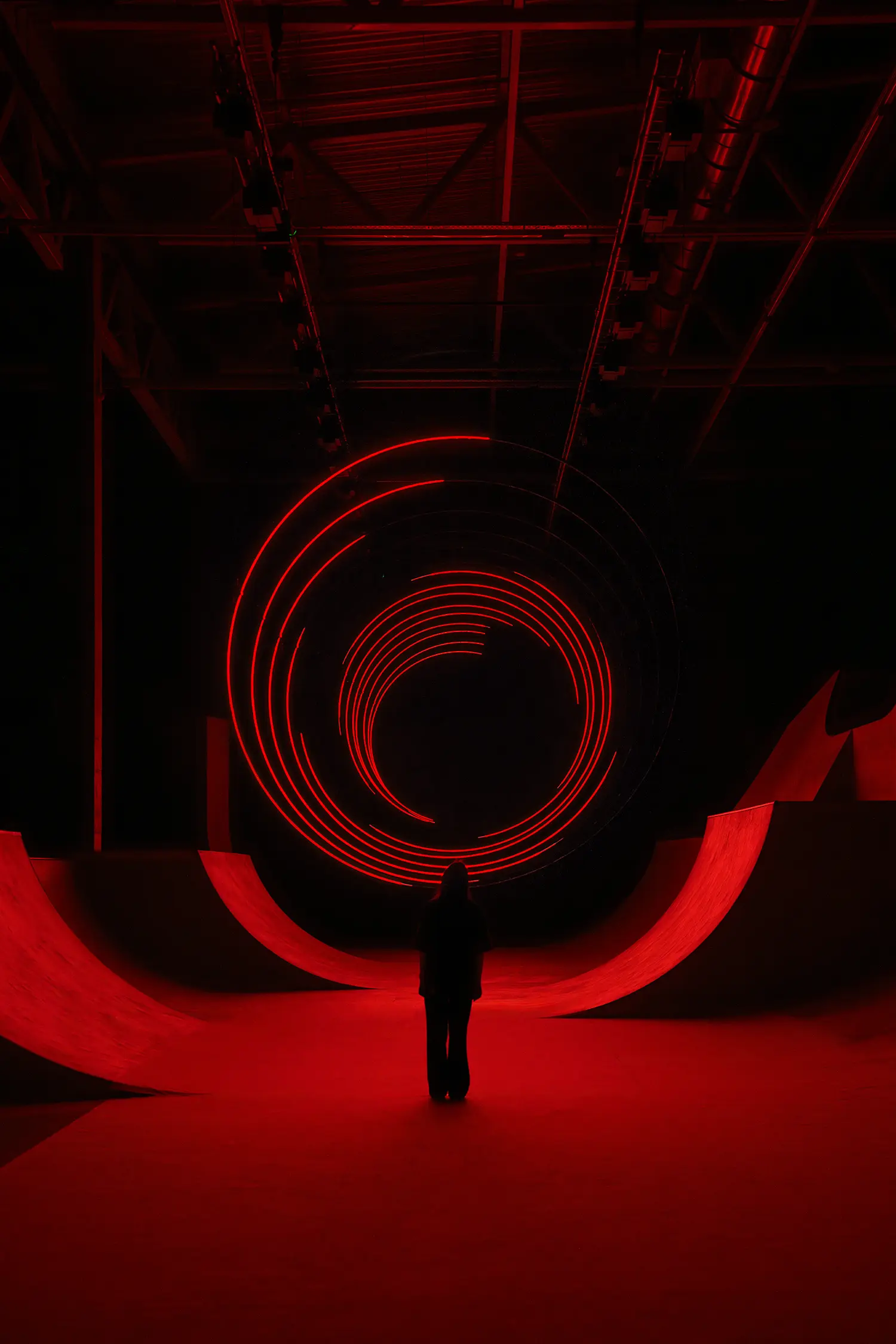 SpY's CYCLES N2 rings captured mid-transition as broken segments of red light above a viewer in Kazan