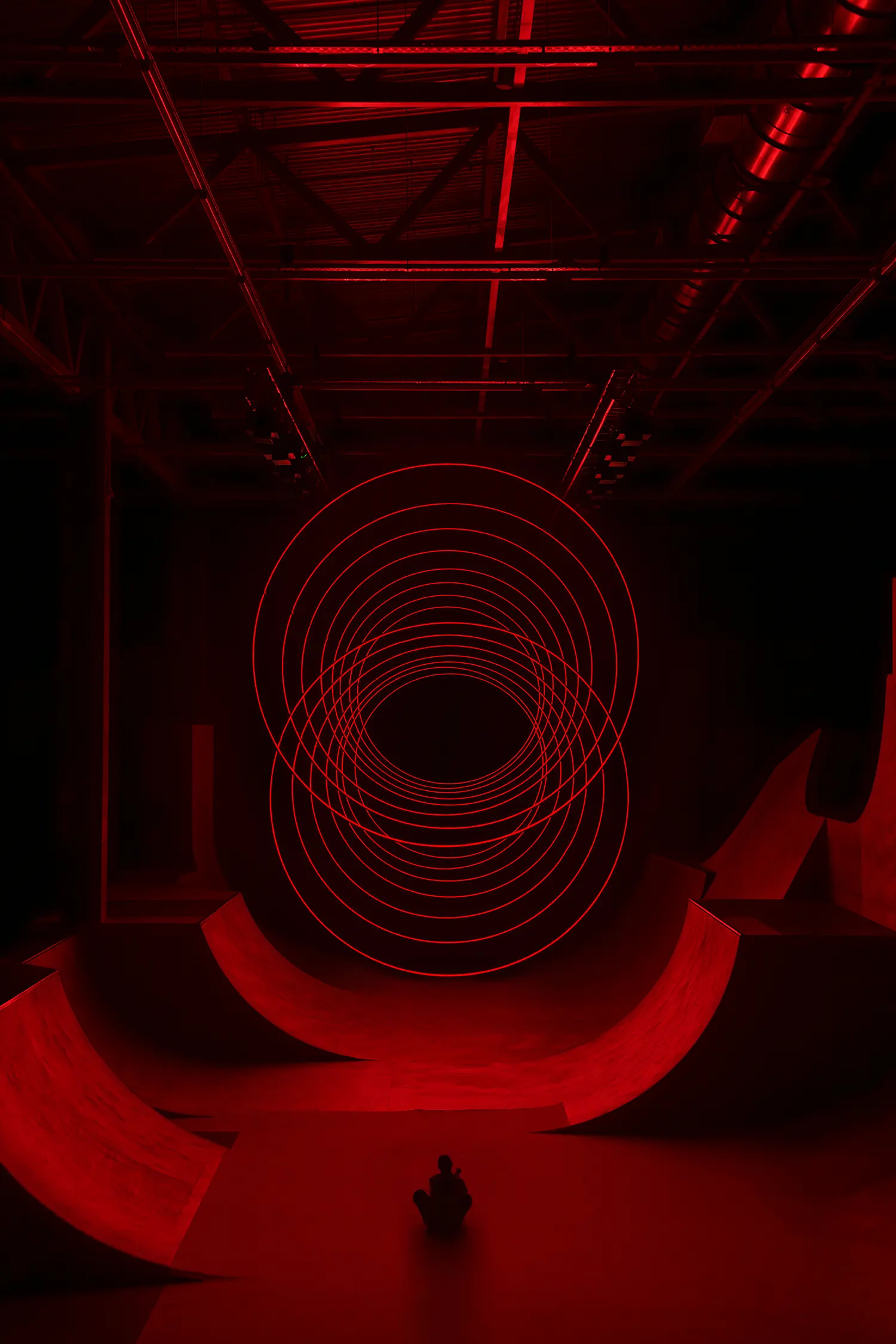 Wide symmetrical view of SpY's CYCLES N2 rings shown as segmented light trails above the ramp-lined Kazan venue