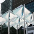 Glacier Project by Dayuan Design, nine suspended white membrane and perforated-metal ice forms on steel poles against Shanghai glass towers