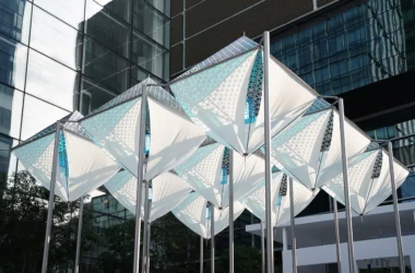 Glacier Project by Dayuan Design, nine suspended white membrane and perforated-metal ice forms on steel poles against Shanghai glass towers