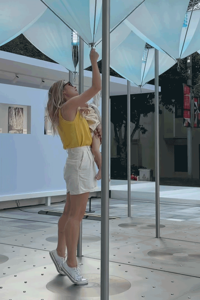 Animation of a visitor pulling a suspended component of Glacier Project by Dayuan Design, the overhead form contracting in response