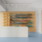 De Cecco Flagship Store by Studio Francesco Faccin, Pescara, wheat sheaf display wall, steel shelving, white stone counter with De Cecco engraving