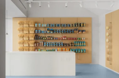 De Cecco Flagship Store by Studio Francesco Faccin, Pescara, wheat sheaf display wall, steel shelving, white stone counter with De Cecco engraving