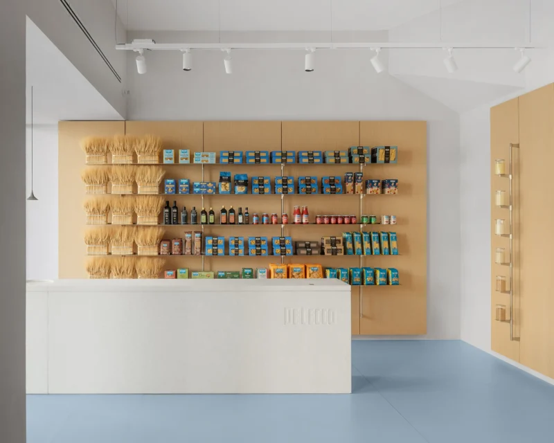 De Cecco Flagship Store by Studio Francesco Faccin, Pescara, wheat sheaf display wall, steel shelving, white stone counter with De Cecco engraving