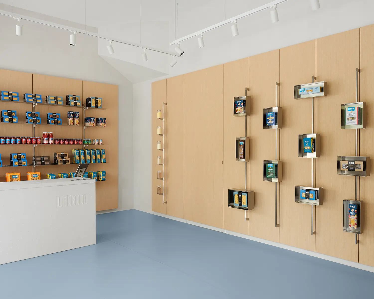 De Cecco Flagship Store by Studio Francesco Faccin, steel display wall with vertical rods, individually framed pasta packages, checkout counter