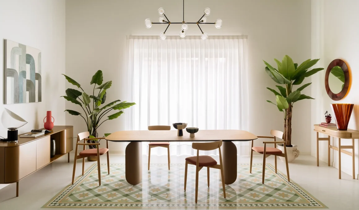 Elia's Home by In-Nova Studio dining area, sage green ceiling, oak table on curved base, geometric terrazzo carpet inlay, Aversa
