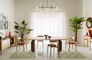 Elia's Home by In-Nova Studio dining area, sage green ceiling, oak table on curved base, geometric terrazzo carpet inlay, Aversa