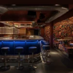 FlipDog basement bar by YOD Group, blue flock counter, WAONE surrealist print upholstery, Shoreditch London