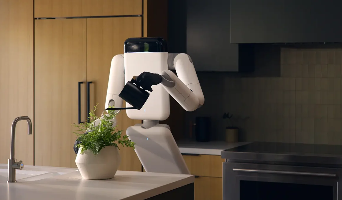 Genesis AI's Eno robot watering a potted fern on a kitchen island, gripping a watering can with its dexterous hand