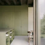 SONO Residence kitchen by Atelier Carle, Wentworth-North, Quebec — olive green cabinetry, oak island, timber ceiling