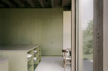 SONO Residence kitchen by Atelier Carle, Wentworth-North, Quebec — olive green cabinetry, oak island, timber ceiling
