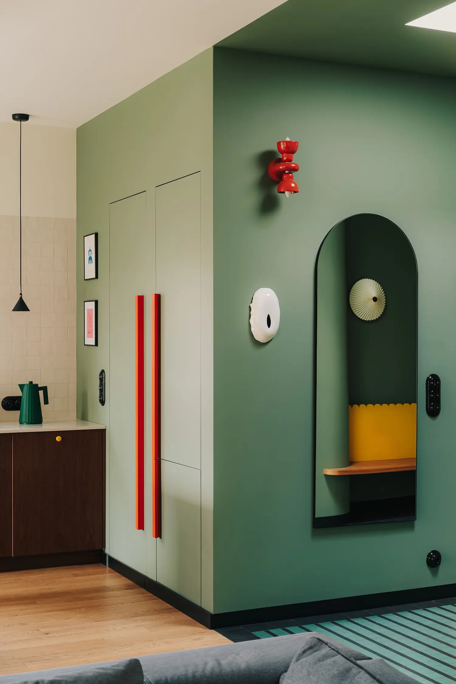 Hornówek House entrance hallway by one desk — feldgrau green walls, patterned floor tile, ceramic collection shelving