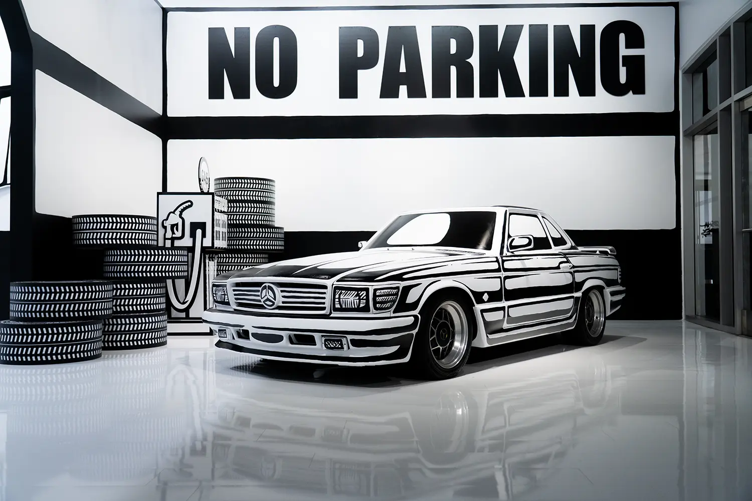 Hand-painted Mercedes-Benz coupe at Joshua Vides Flat Out exhibition, front view beneath large No Parking wall graphic