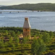 Kola Bay Lighthouse Viewpoint by Timber Architecture Workshop, wide view over the bay, bridge, and hillside vegetation