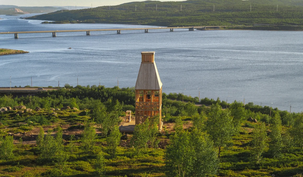 Kola Bay Lighthouse Viewpoint by Timber Architecture Workshop, wide view over the bay, bridge, and hillside vegetation