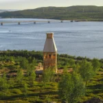 Kola Bay Lighthouse Viewpoint by Timber Architecture Workshop, wide view over the bay, bridge, and hillside vegetation